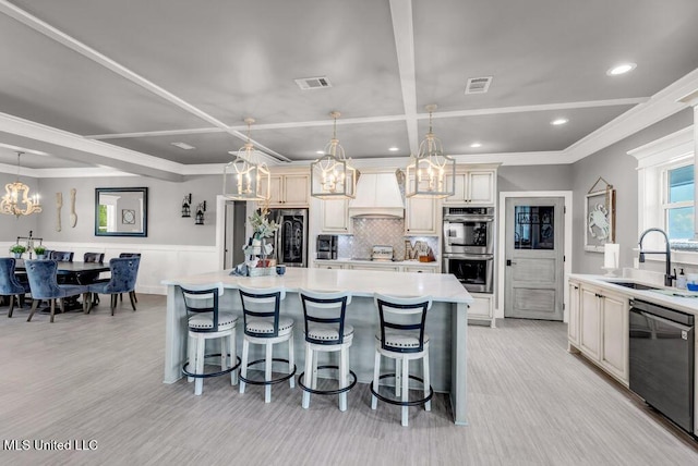 15225 Branigar, Biloxi, MS 39532 - kitchen with a chandelier, stainless steel appliances, custom range hood, light countertops, and a breakfast bar