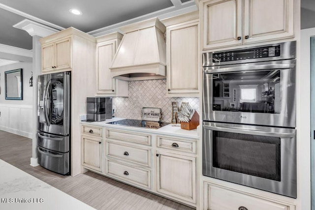 15225 Branigar, Biloxi, MS 39532 - kitchen with stainless steel appliances, cream cabinetry, premium range hood, light countertops, and backsplash