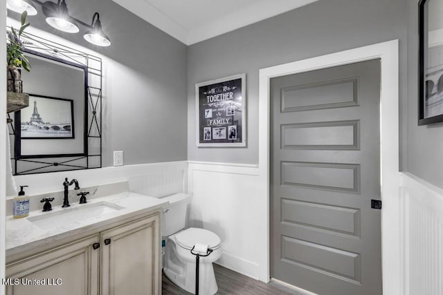 15225 Branigar, Biloxi, MS 39532 - half bathroom featuring vanity, wainscoting, wood finished floors, and a decorative wall