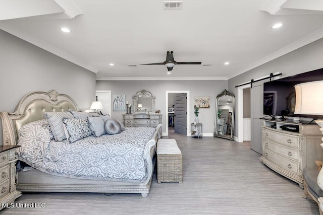 15225 Branigar, Biloxi, MS 39532 - bedroom with a barn door, ornamental molding, wood finished floors, recessed lighting, and a ceiling fan
