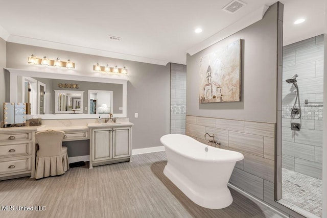 15225 Branigar, Biloxi, MS 39532 - bathroom featuring walk in shower, vanity, a freestanding tub, tile walls, and recessed lighting