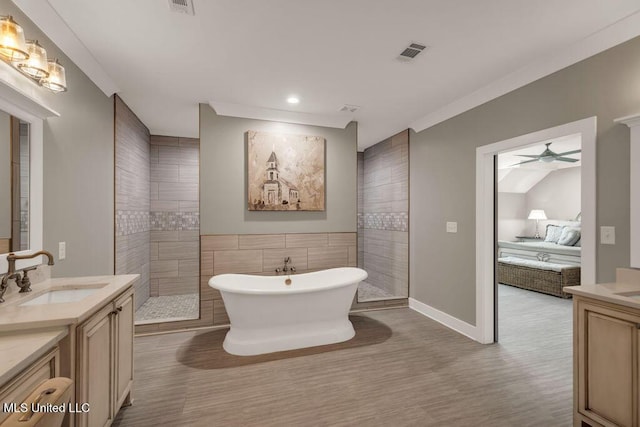 15225 Branigar, Biloxi, MS 39532 - ensuite bathroom featuring vanity, a freestanding bath, a ceiling fan, walk in shower, and tile walls