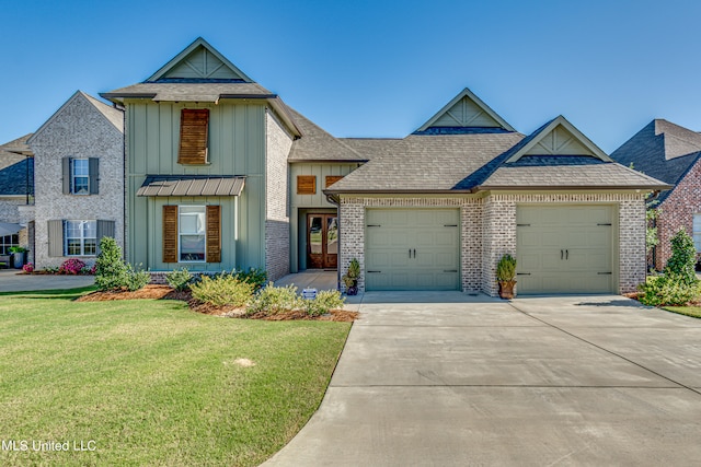 view of front of property with a front yard and a garage