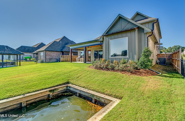 back of property featuring cooling unit, a patio area, and a lawn