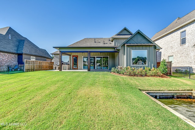 rear view of property with a yard