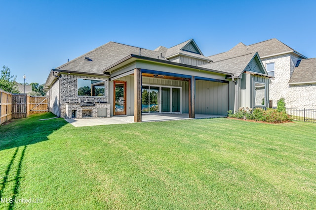 rear view of house featuring a patio and a yard