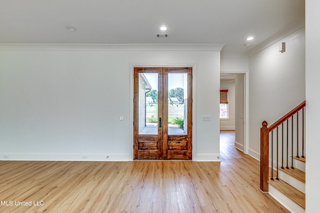 entryway featuring french doors, light hardwood / wood-style floors, and ornamental molding