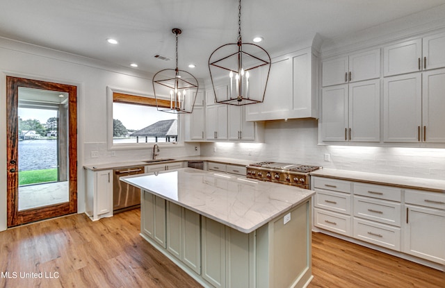 kitchen featuring white cabinets, a center island, sink, and stainless steel appliances