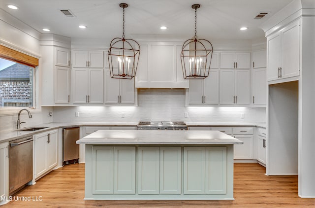 kitchen featuring a kitchen island, light hardwood / wood-style flooring, hanging light fixtures, and stainless steel appliances