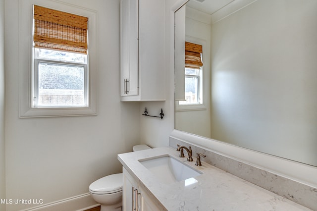 bathroom featuring toilet, crown molding, and vanity