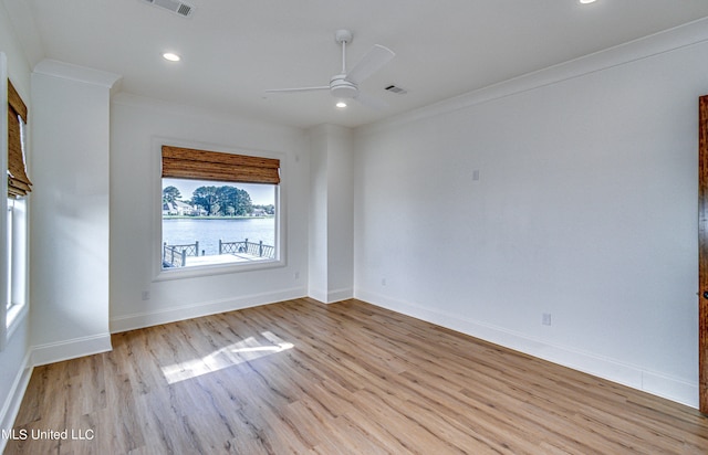 unfurnished room featuring ceiling fan, ornamental molding, and light wood-type flooring