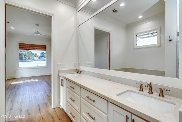 bathroom with vanity, wood-type flooring, plenty of natural light, and ceiling fan