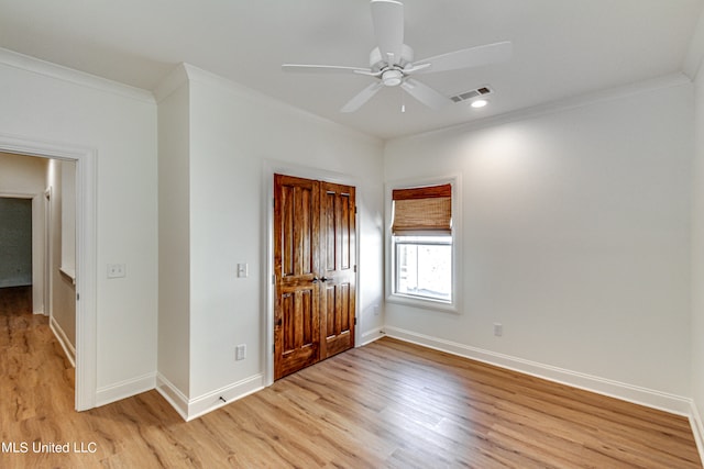 unfurnished bedroom featuring a closet, ceiling fan, crown molding, and light wood-type flooring