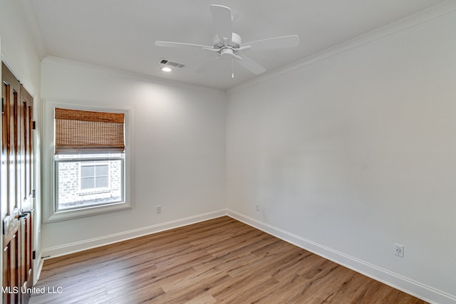 unfurnished room with crown molding, light wood-type flooring, and ceiling fan