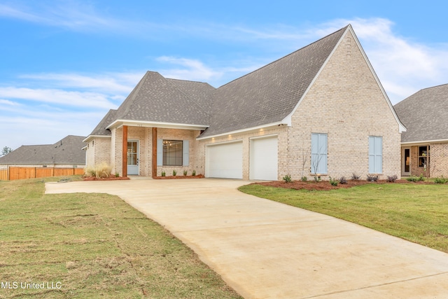 view of front of home with a front yard and a garage