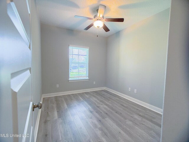 5807 Sylvester St, Ocean Springs, MS 39564 - spare room with wood finished floors, a ceiling fan, and baseboards