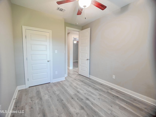 5807 Sylvester St, Ocean Springs, MS 39564 - unfurnished bedroom with baseboards, wood finished floors, and a ceiling fan