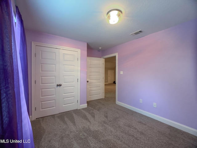 5807 Sylvester St, Ocean Springs, MS 39564 - unfurnished bedroom featuring baseboards, carpet floors, and a closet