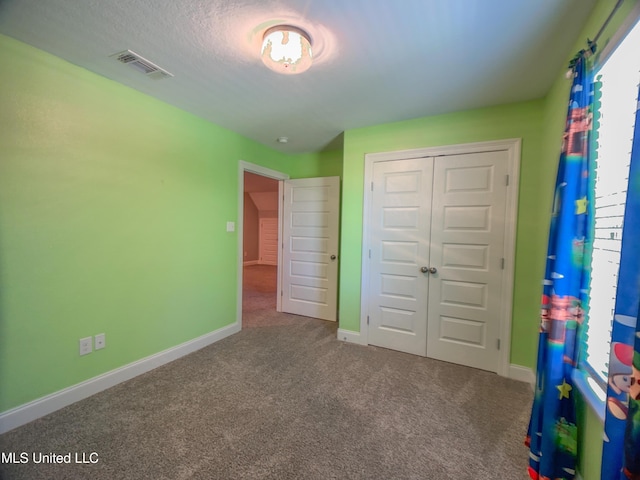 5807 Sylvester St, Ocean Springs, MS 39564 - unfurnished bedroom featuring carpet flooring, a closet, and baseboards