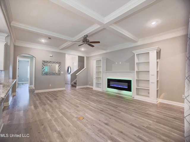 5807 Sylvester St, Ocean Springs, MS 39564 - unfurnished living room with arched walkways, a ceiling fan, light wood-type flooring, a glass covered fireplace, and ornamental molding