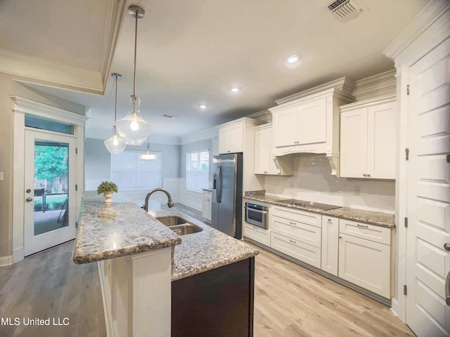 5807 Sylvester St, Ocean Springs, MS 39564 - kitchen with stainless steel appliances, a sink, ornamental molding, light wood-style flooring, and white cabinetry