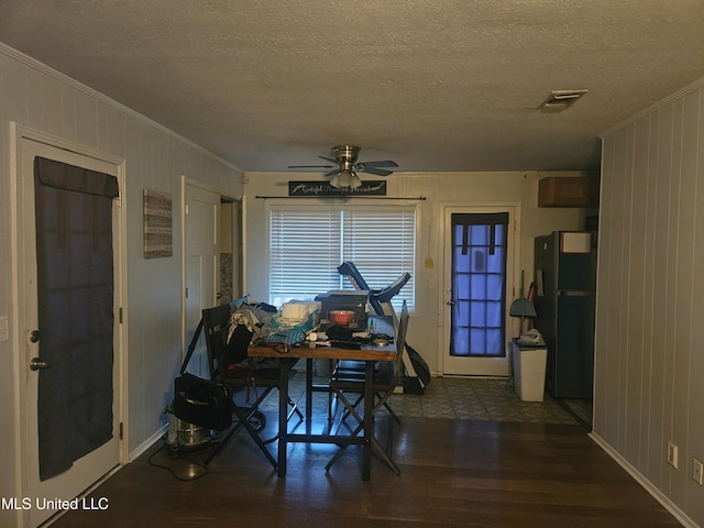 dining room with ceiling fan, visible vents, wood finished floors, and ornamental molding