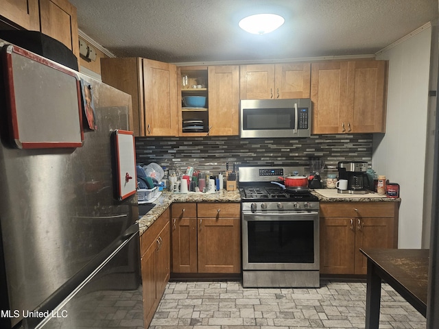 kitchen with decorative backsplash, open shelves, a textured ceiling, and stainless steel appliances