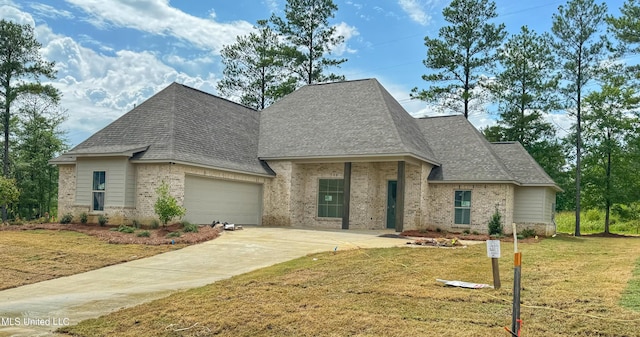 french provincial home with a front yard and a garage