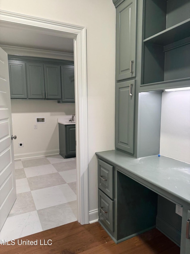 laundry room with cabinets, ornamental molding, and hookup for a washing machine