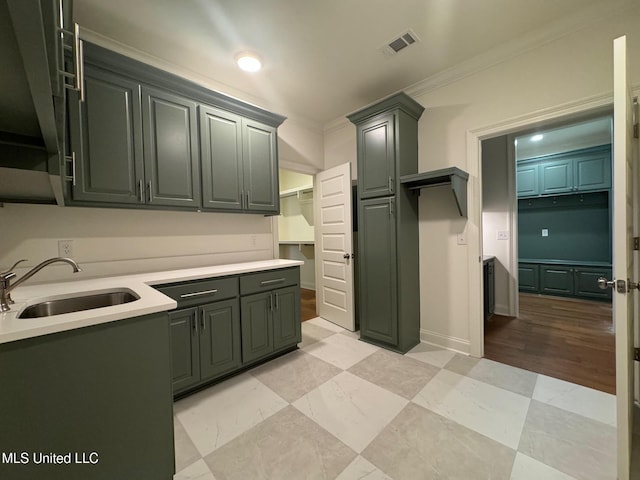 kitchen with crown molding and sink