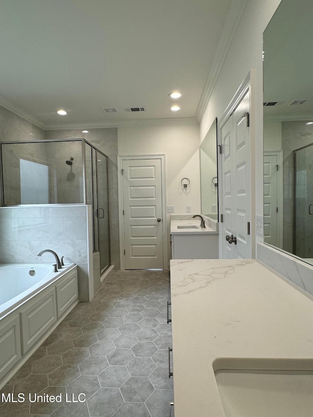 bathroom featuring tile patterned flooring, vanity, separate shower and tub, and ornamental molding