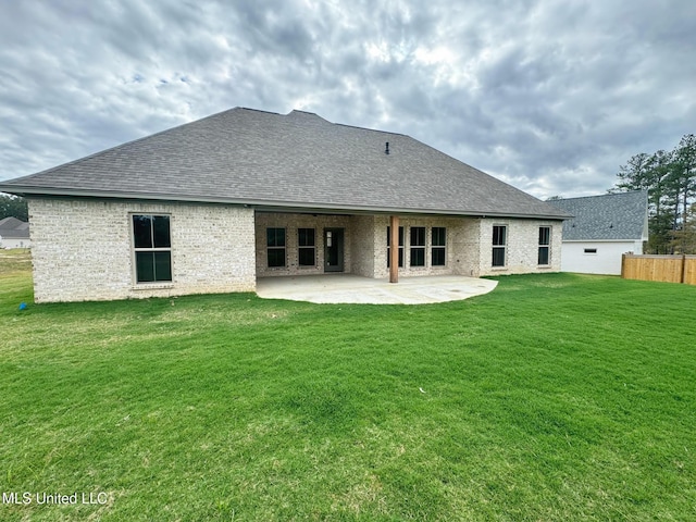 rear view of house with a patio area and a yard