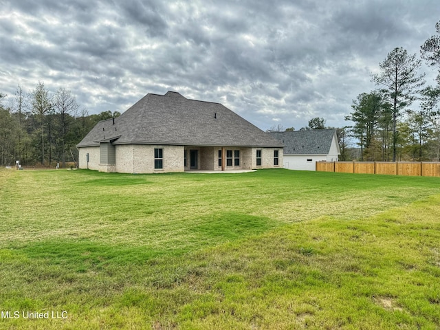 back of property featuring a lawn