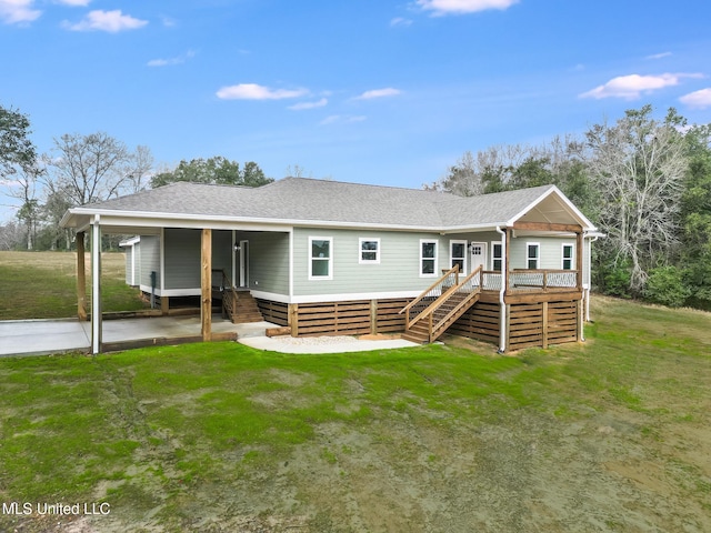 view of front of property featuring covered porch, roof with shingles, stairway, and a front yard