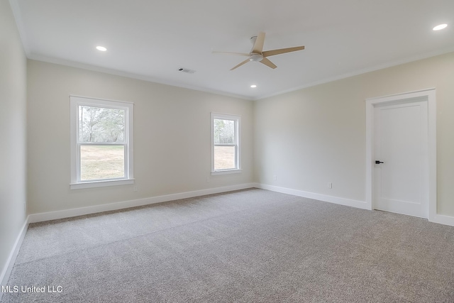 empty room featuring carpet floors, ornamental molding, visible vents, and baseboards