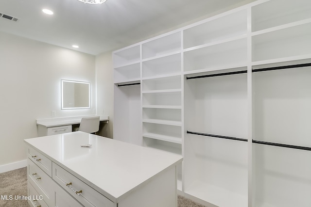 spacious closet featuring light colored carpet and visible vents