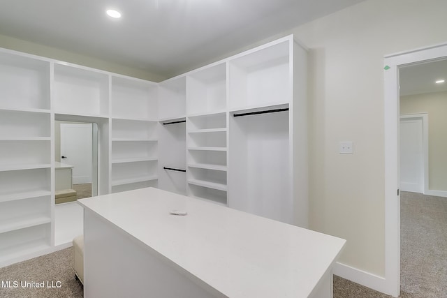 spacious closet featuring light colored carpet