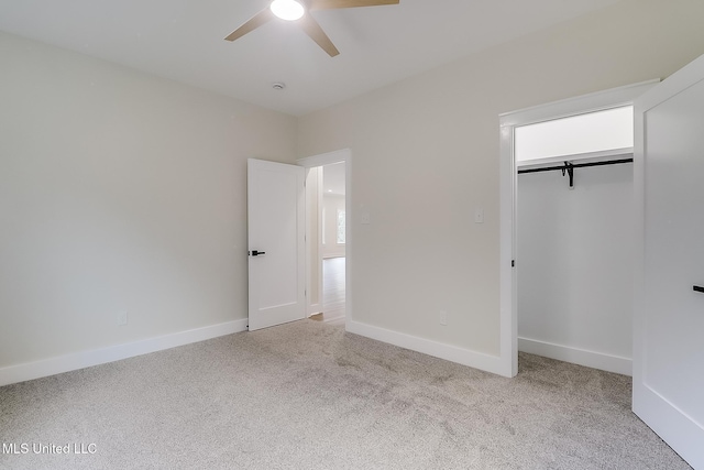 unfurnished bedroom featuring a closet, light colored carpet, ceiling fan, and baseboards