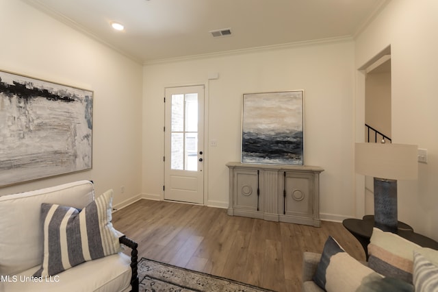 living room featuring hardwood / wood-style flooring and ornamental molding