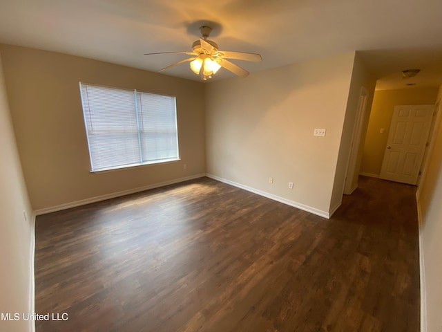 unfurnished room featuring dark wood-type flooring and ceiling fan