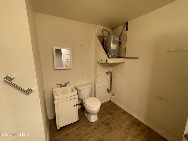 3701 14th St, Gulfport, MS 39501 - bathroom featuring water heater, wood finished floors, toilet, a shower, and vanity