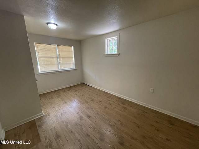 3701 14th St, Gulfport, MS 39501 - unfurnished room with a textured ceiling, baseboards, and wood finished floors