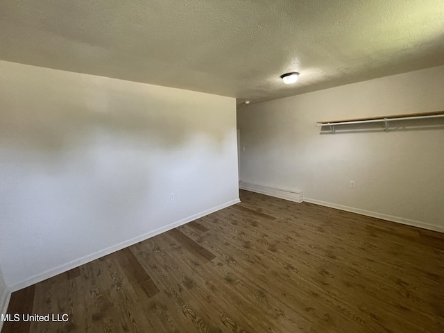 3701 14th St, Gulfport, MS 39501 - spare room featuring dark wood-type flooring, baseboards, and a textured ceiling