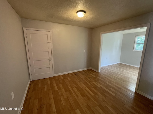 3701 14th St, Gulfport, MS 39501 - spare room with wood finished floors, a textured ceiling, and baseboards