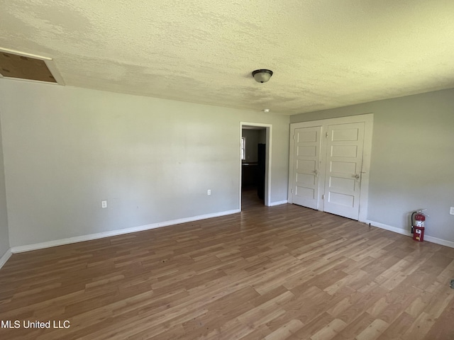 3701 14th St, Gulfport, MS 39501 - unfurnished bedroom featuring wood finished floors, a textured ceiling, baseboards, and a closet