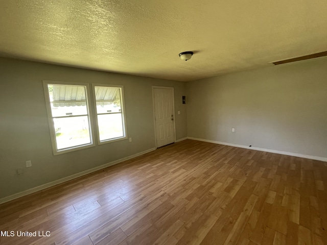 3701 14th St, Gulfport, MS 39501 - spare room featuring wood finished floors, baseboards, and a textured ceiling