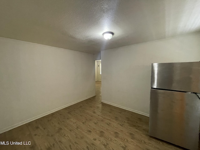 3701 14th St, Gulfport, MS 39501 - interior space with freestanding refrigerator, a textured ceiling, wood finished floors, and baseboards