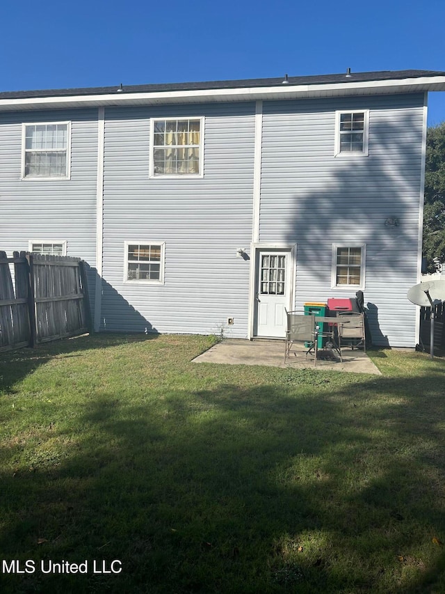 back of house featuring a patio area and a yard