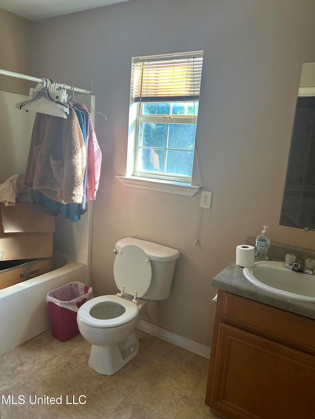 bathroom with tile patterned flooring, vanity, toilet, and a washtub