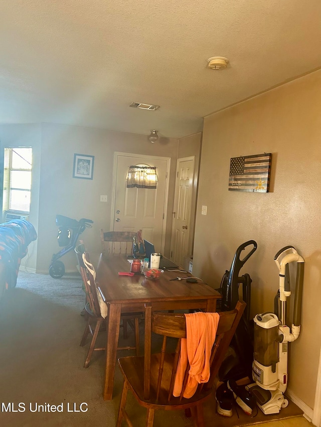 dining room with a textured ceiling